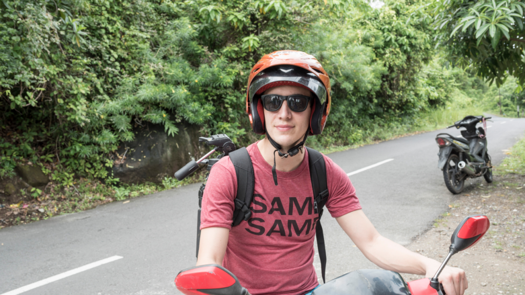 Scooter rider traveling on a road in Bali