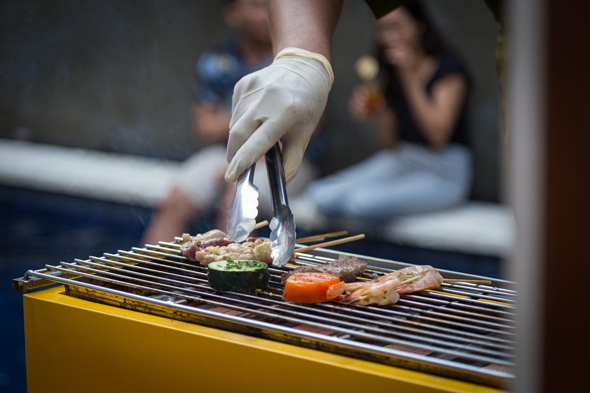Chef grilling at an in-villa BBQ dinner station at The Bidadari Villas & Spa