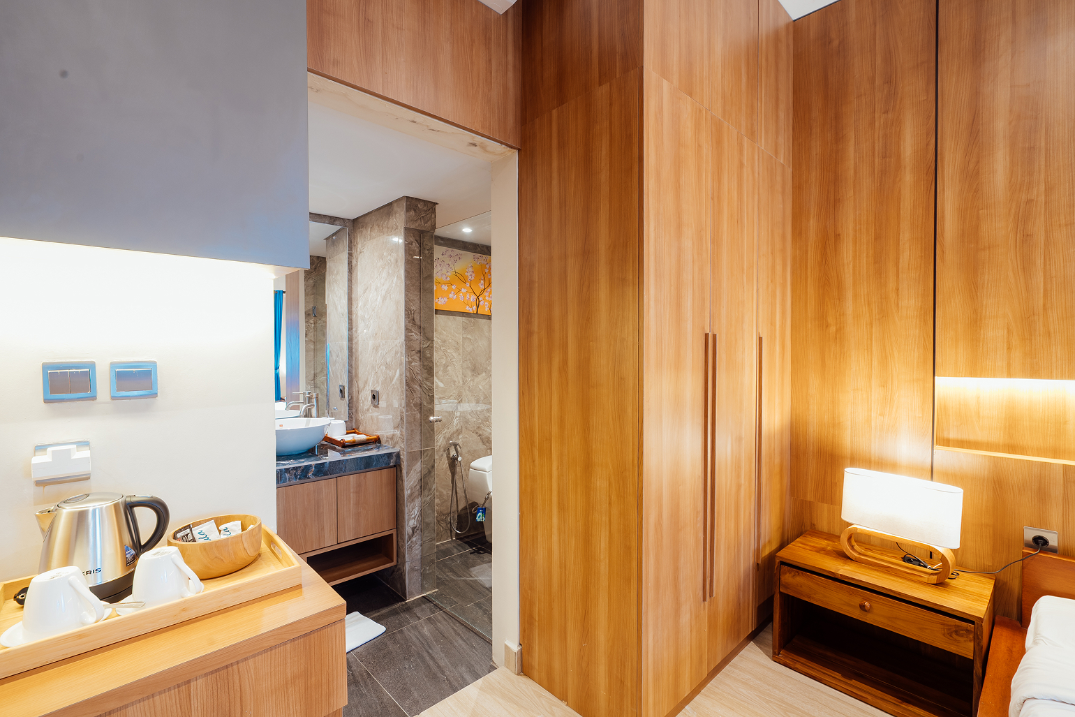 King bed with wood-panelled wall in a villa bedroom, The Bidadari