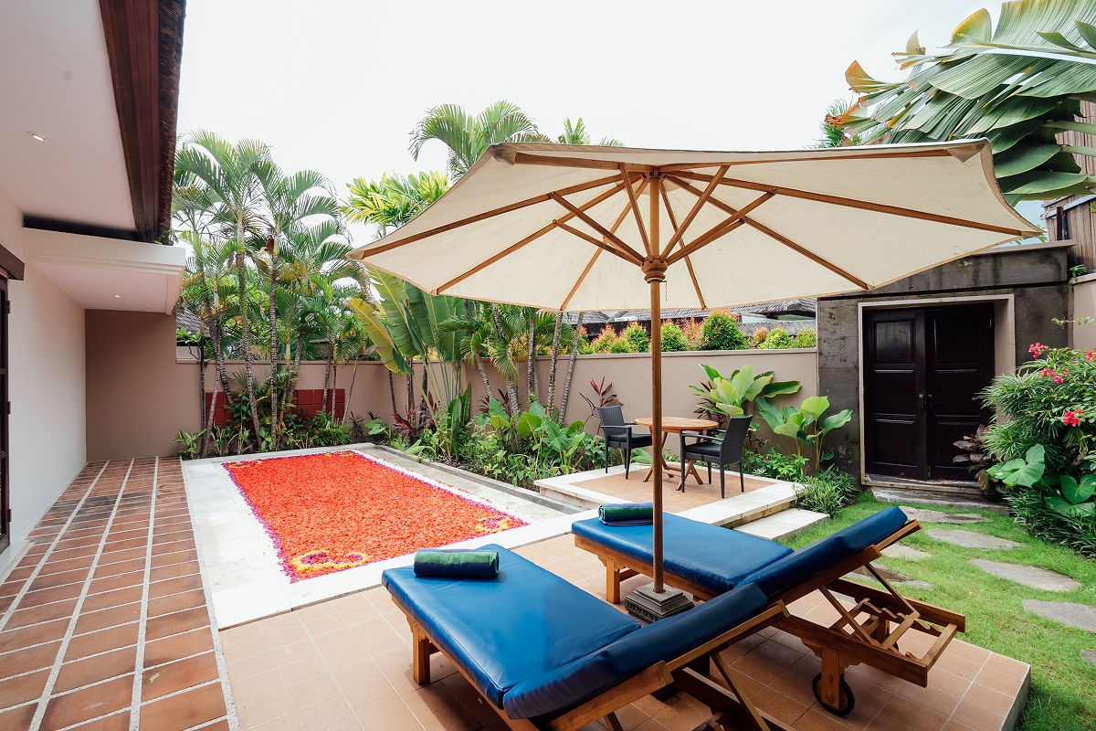 Garden day-bed and parasol on the lawn at The Bidadari Villas & Spa