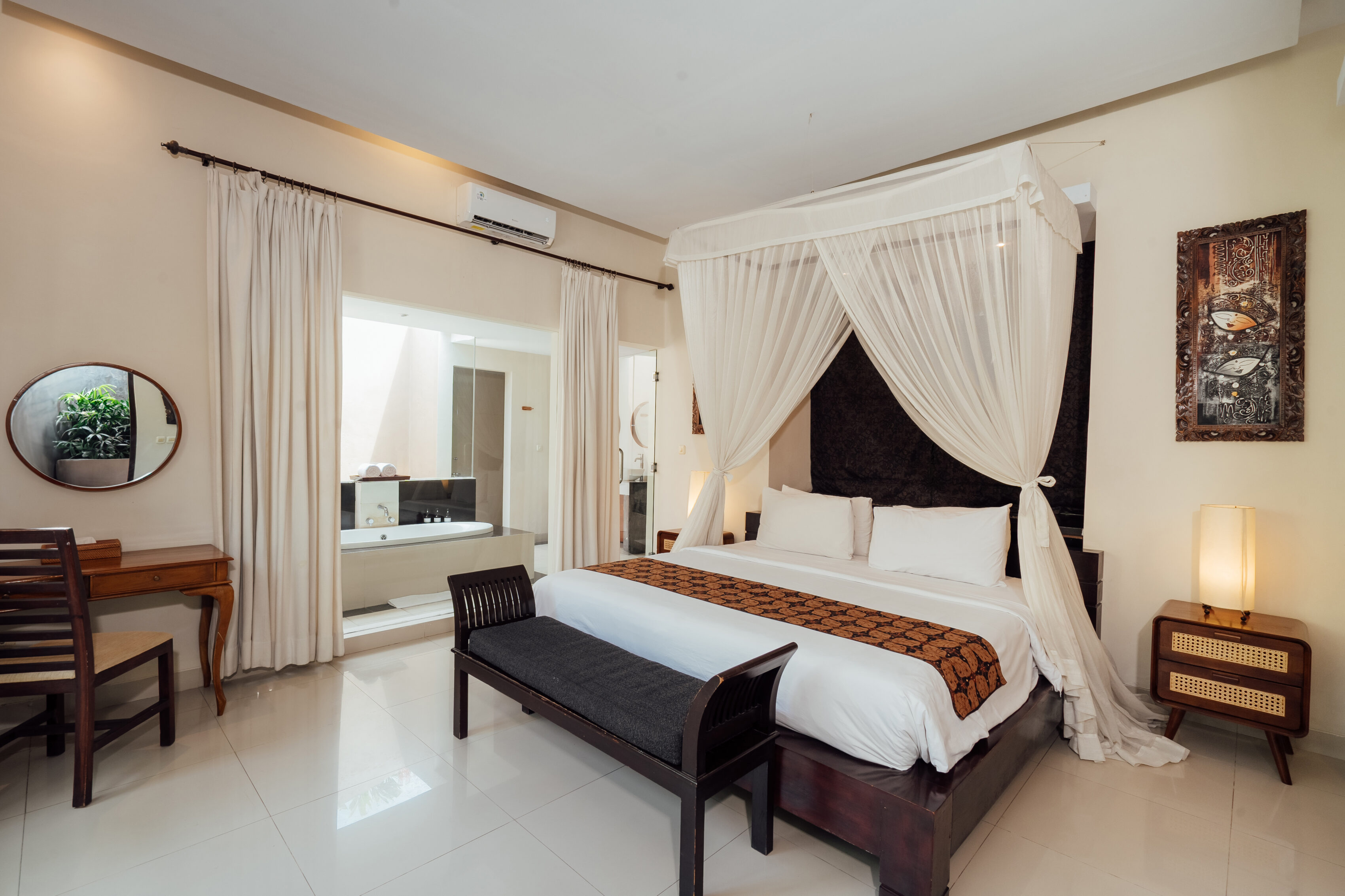 Four-poster canopy king bed with dark wood dressing table, The Bidadari villa