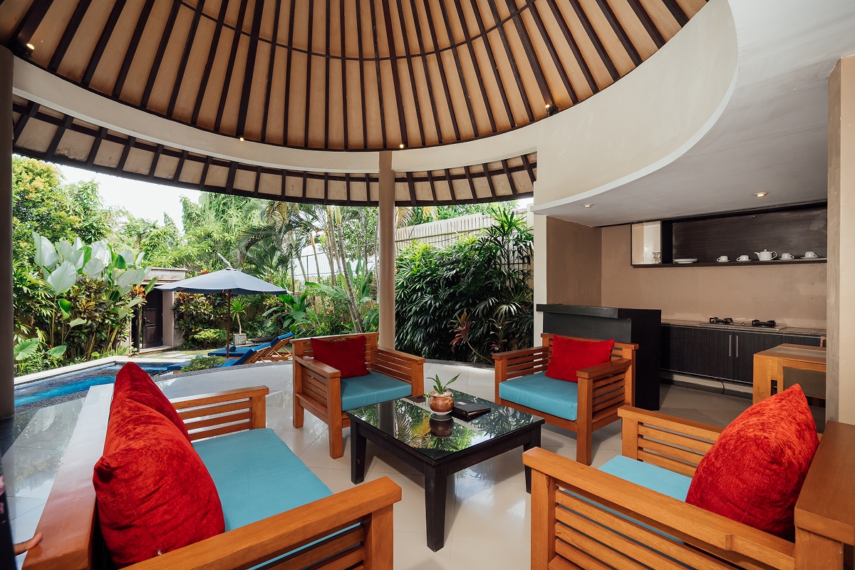 Open lounge under a high alang-alang thatched ceiling with sofas, The Bidadari