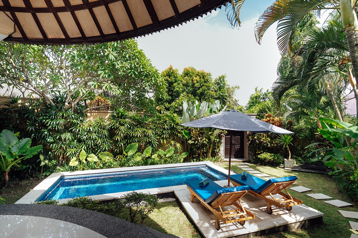 Private swimming pool with sun loungers beside a villa, The Bidadari Villas & Spa