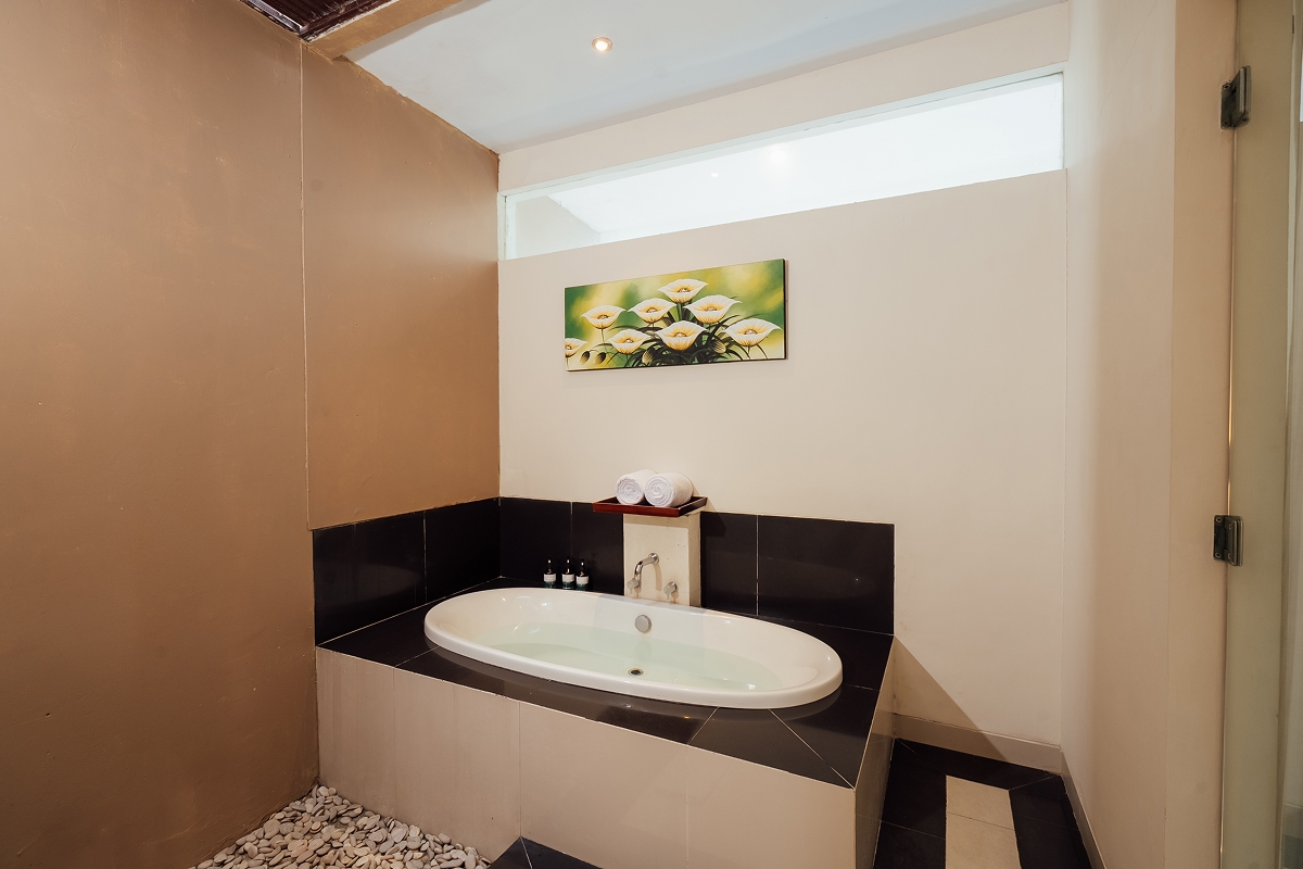 En-suite bathroom with freestanding oval bathtub and plants, The Bidadari