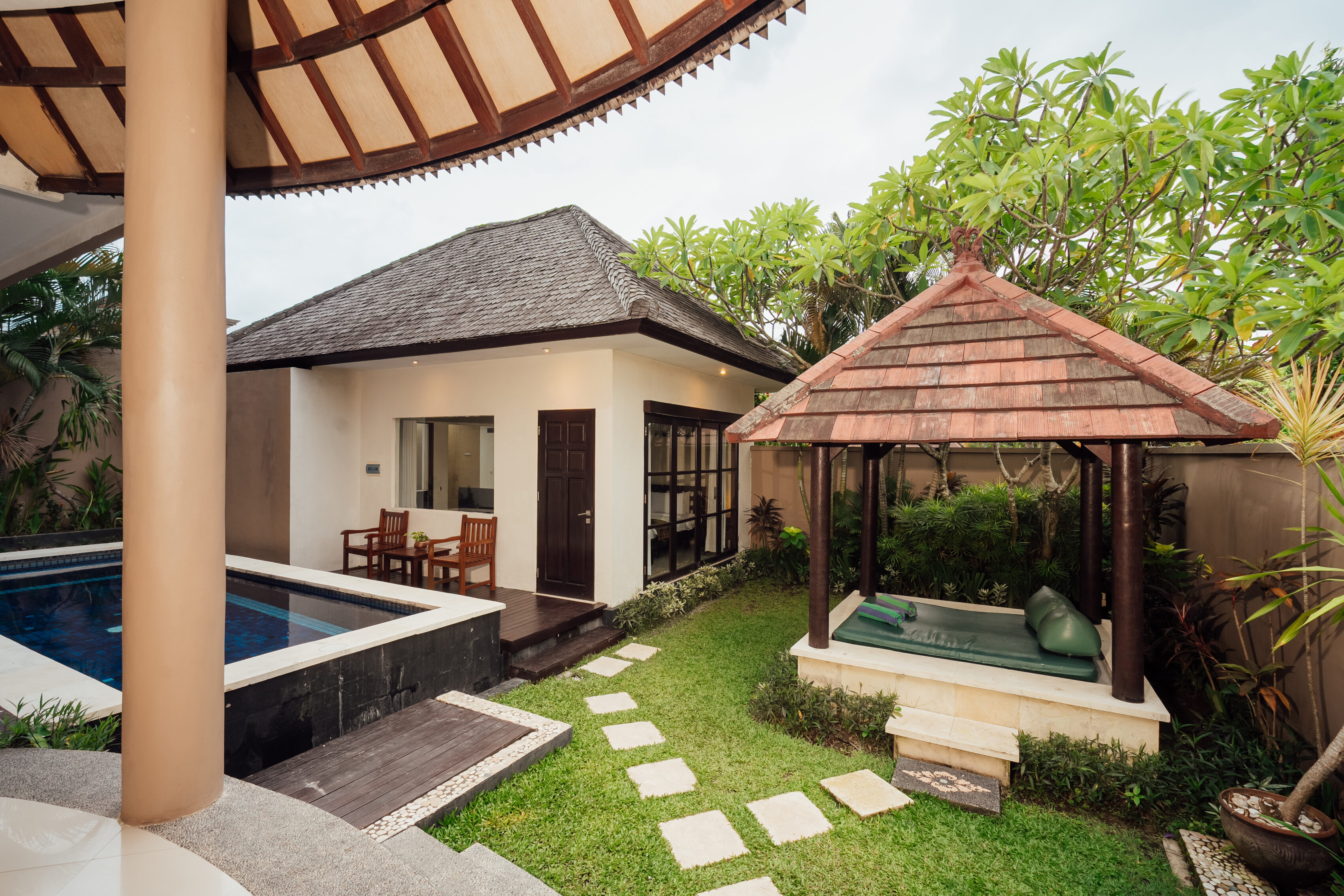Private pool villa with thatched garden gazebo, lawn and sun loungers, The Bidadari