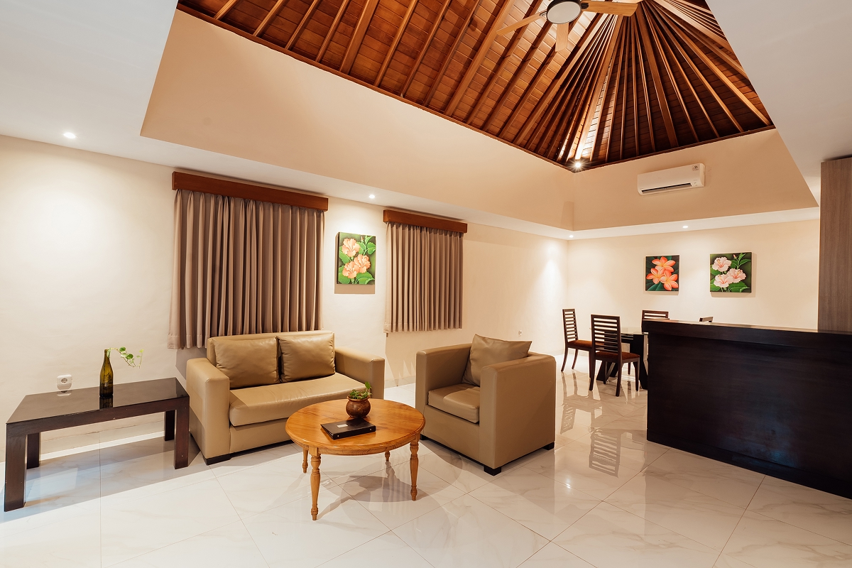 Villa living room with sofa, dark wood credenza and framed art, The Bidadari