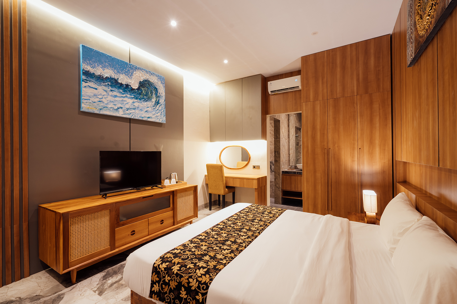 King bed with wood-panelled wall and batik runner in a Bidadari Sanctuary Room
