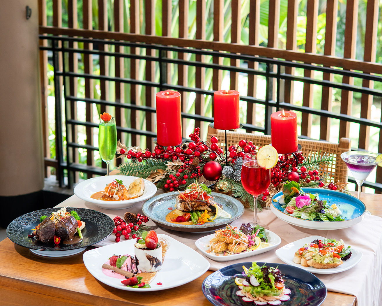 Table set with Balinese and Indonesian dishes and red candles at Yubi Restaurant, The Bidadari