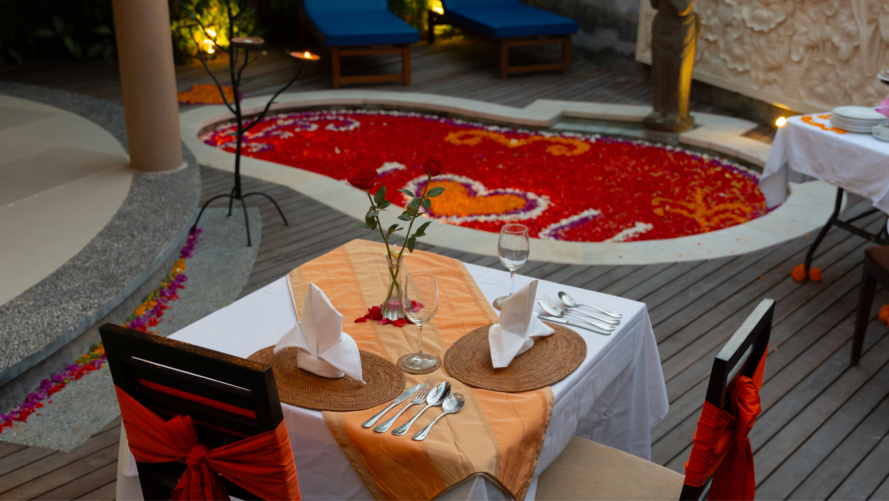 Bathtub filled with red rose petals and candles in a villa bathroom, The Bidadari