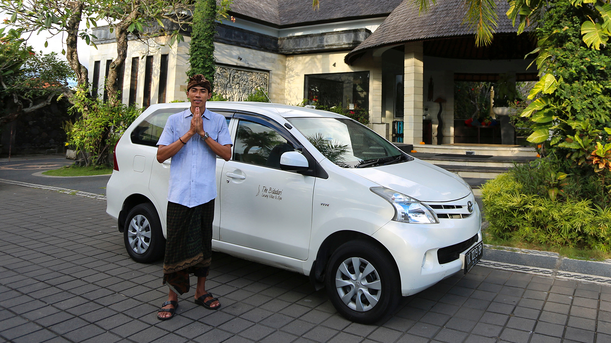 Guide beside a private car arranged for a Bali day tour, The Bidadari