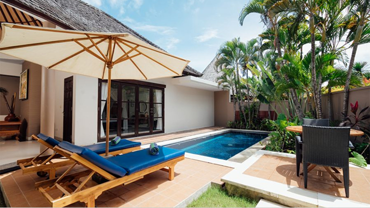 aPool villa with blue parasol and sun loungers, The Bidadari